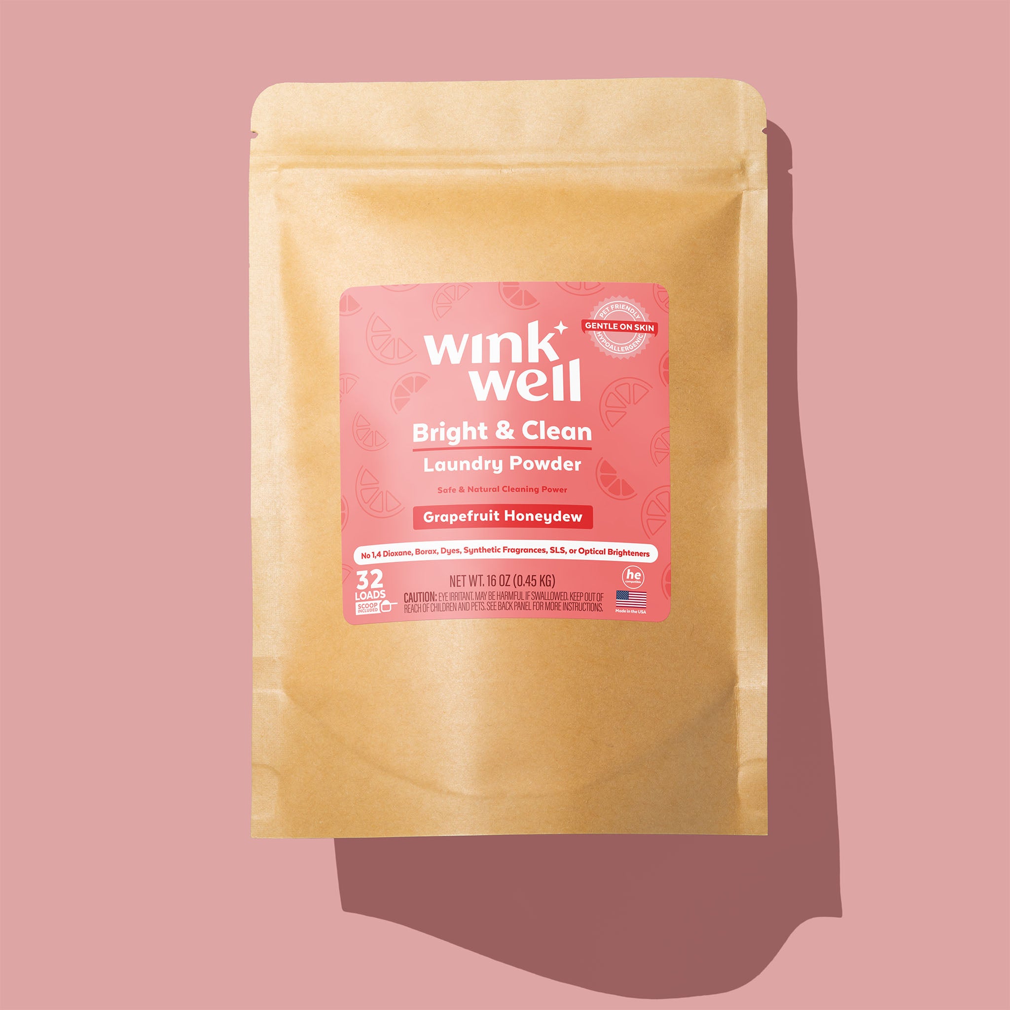 A Wink Well Grapefruit Honeydew Bright & Clean Laundry Powder package on a pink background