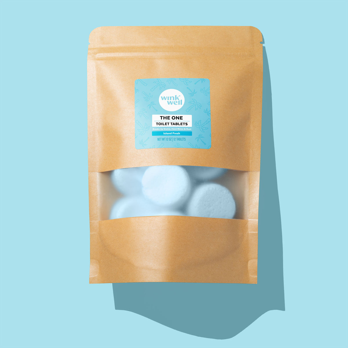 A package of Wink Well The One Toilet Tablets in Island Fresh scent, on a blue background