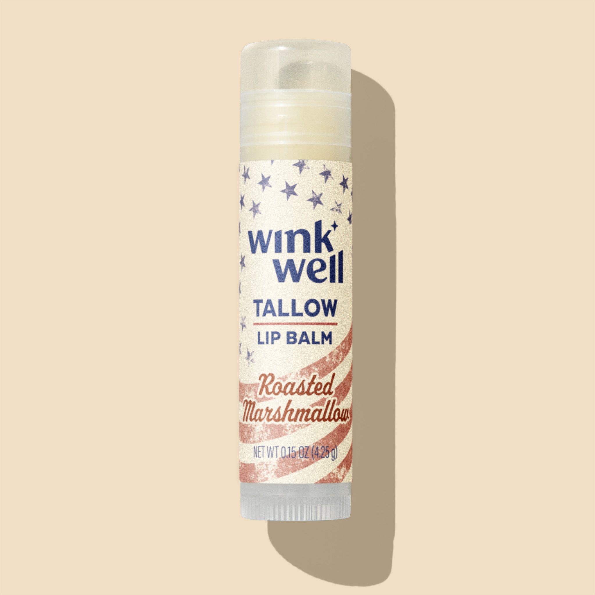 Wink Well tallow lip balm with roasted marshmallow flavor on a beige background, with a patriotic American stars and stripes design.