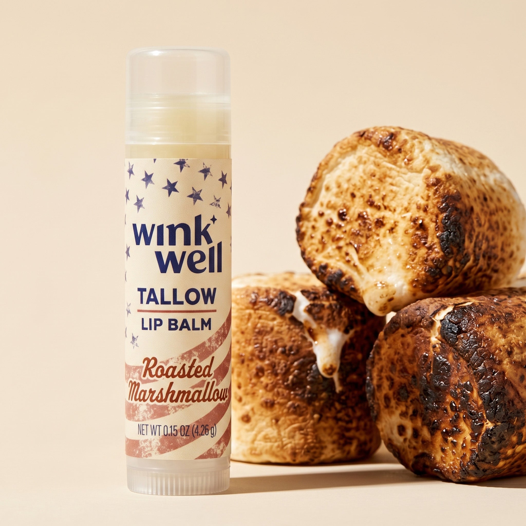Wink Well tallow lip balm with roasted marshmallows on a beige background, with a patriotic American stars and stripes design.