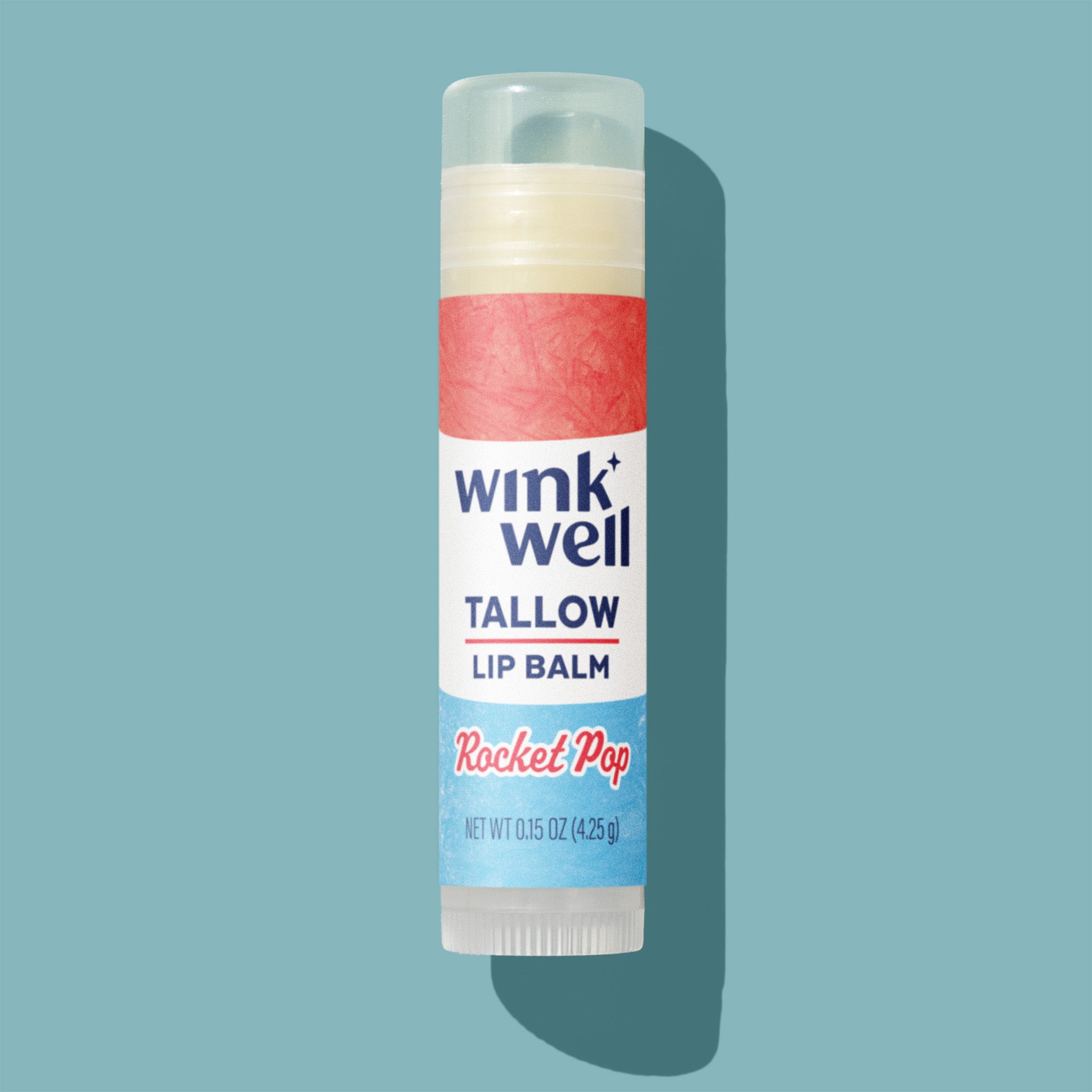 Wink Well Rocket Pop flavored tallow lip balm stick with red, white and blue label on a light blue background