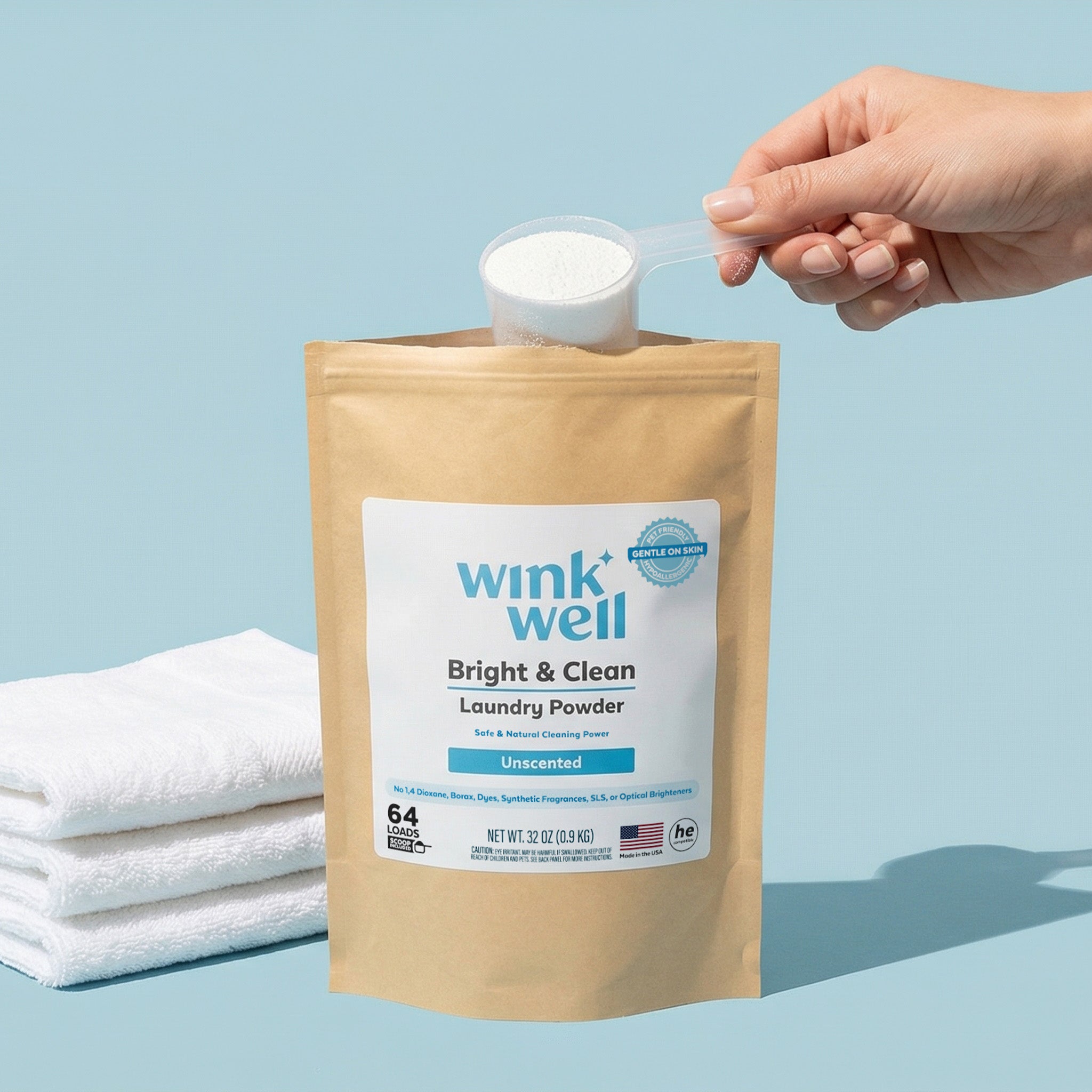 Wink Well laundry powder package with a hand pouring powder, on a light blue background.