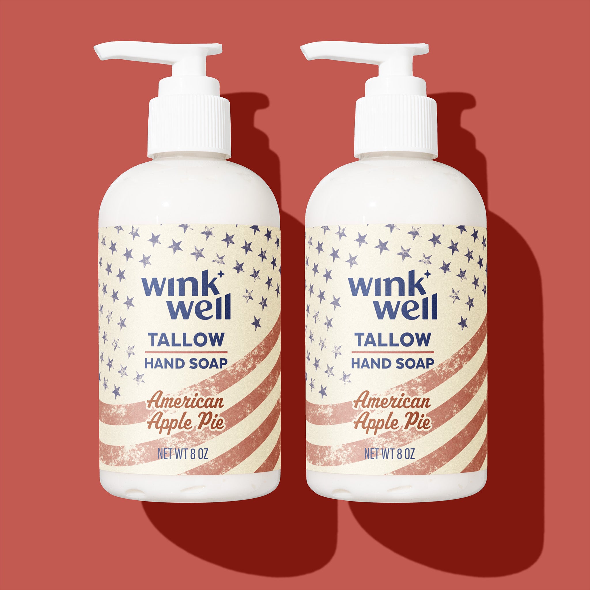 Two bottles of Wink Well Tallow Hand Soap with 'American Apple Pie' scent on a red background.